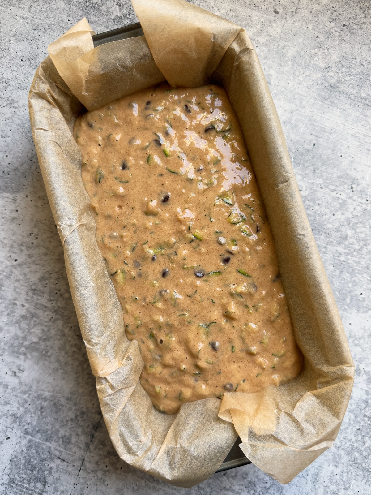 Batter in lined loaf pan.