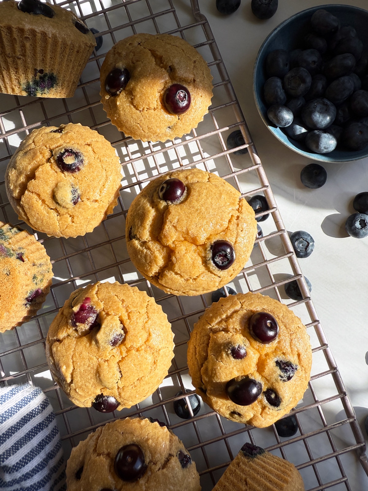 Cassava flour blueberry muffins on wire cooling rack.
