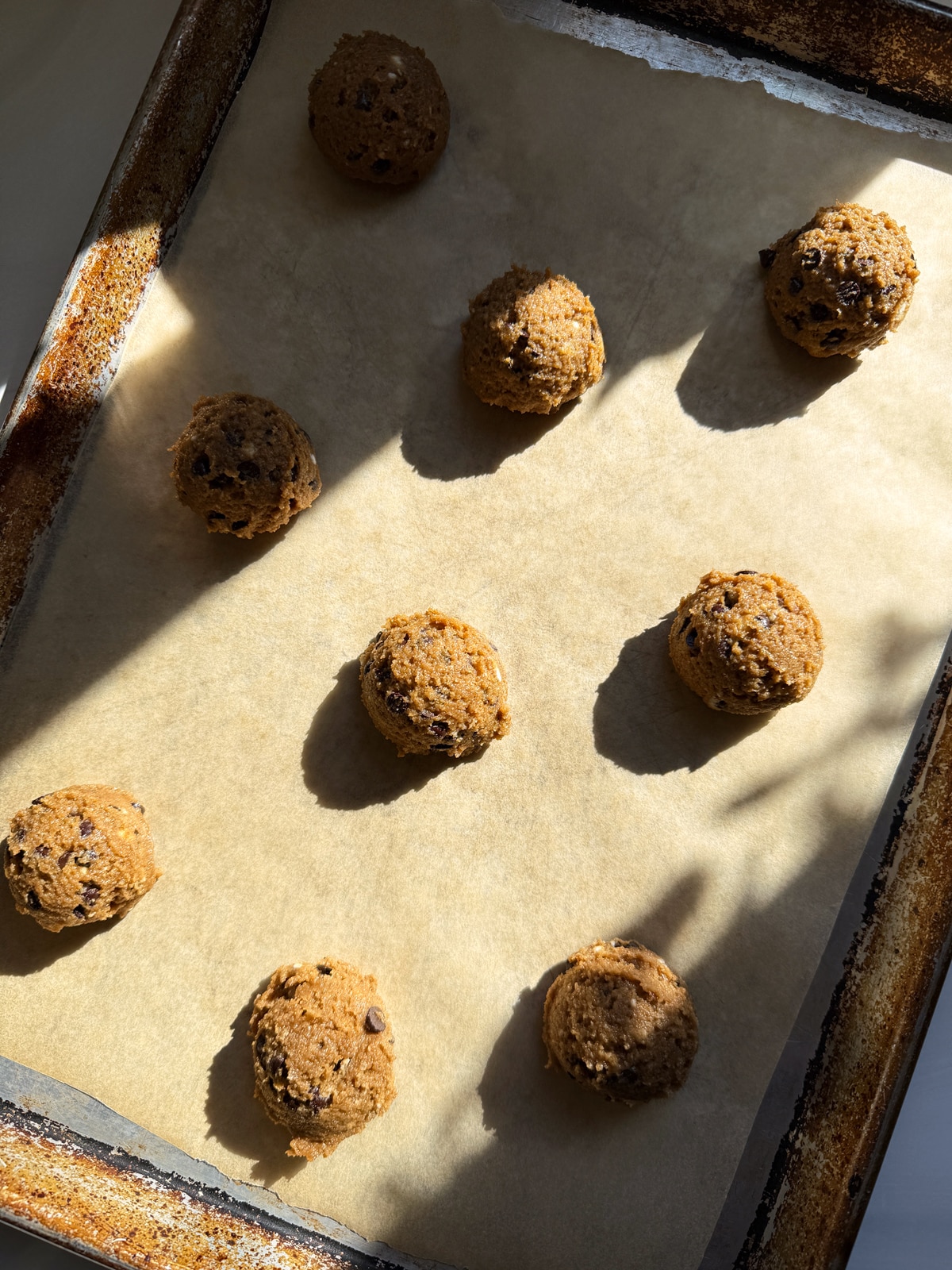 Unbaked cookie dough on lined baking sheet.
