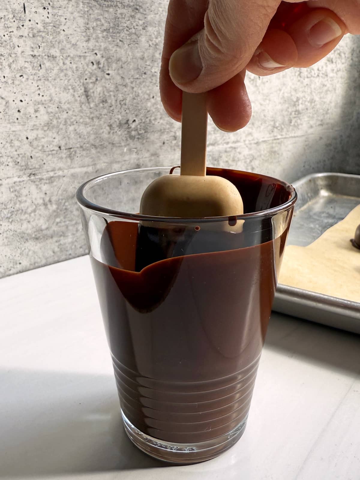 Dipping the bars in melted chocolate.