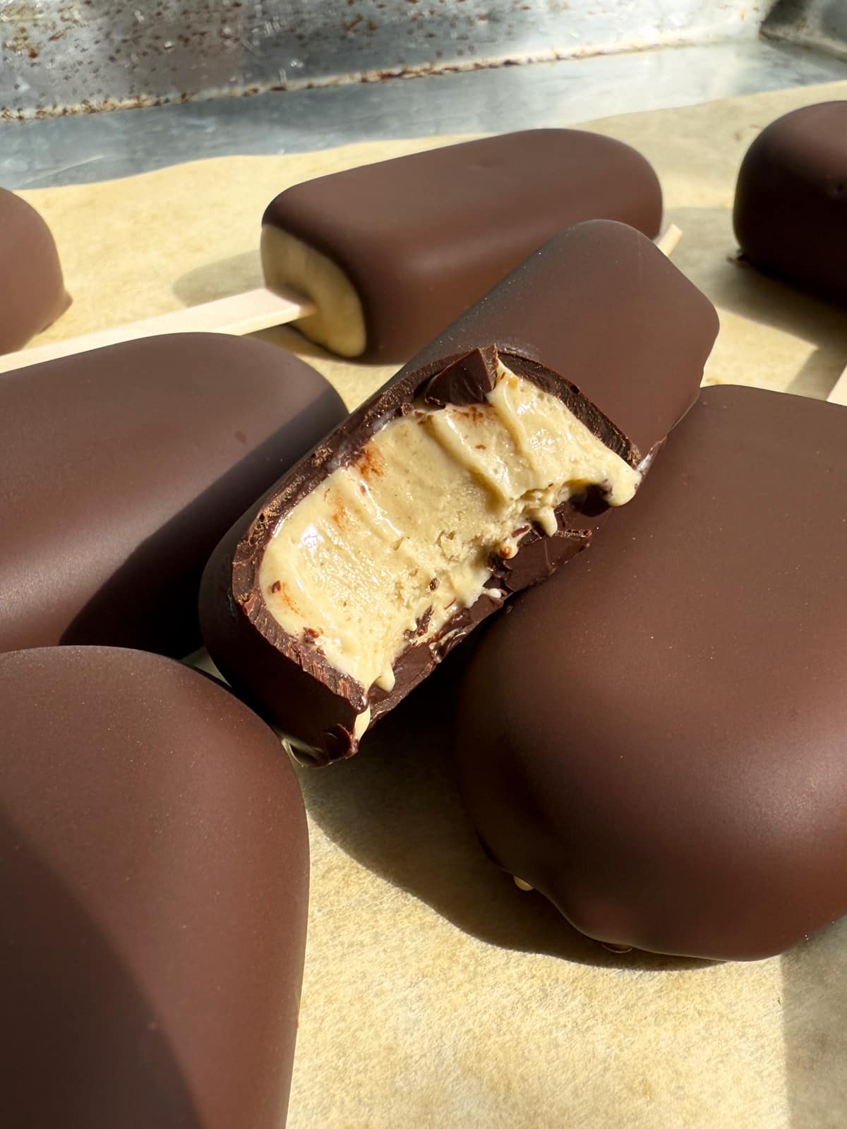 Close up of a bite of an ice cream bar to show the frozen texture.