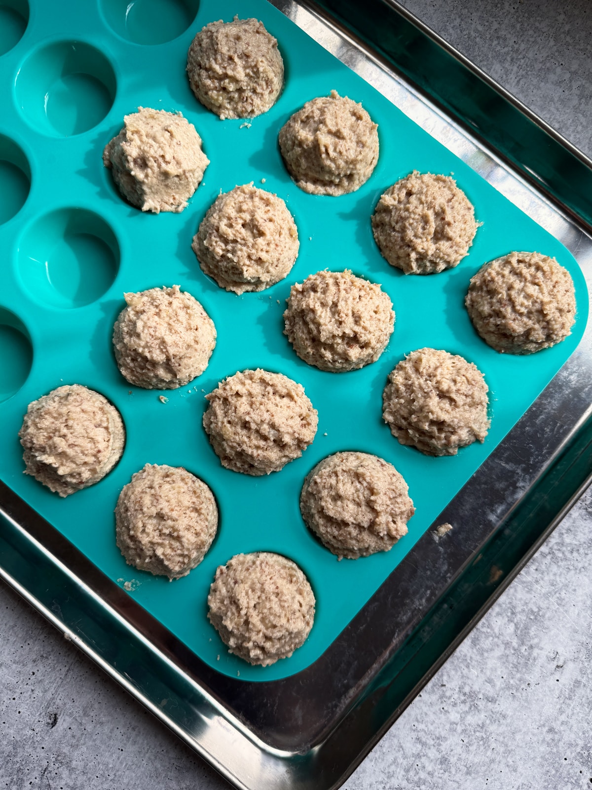 Muffin batter in mini silicone muffin pan.