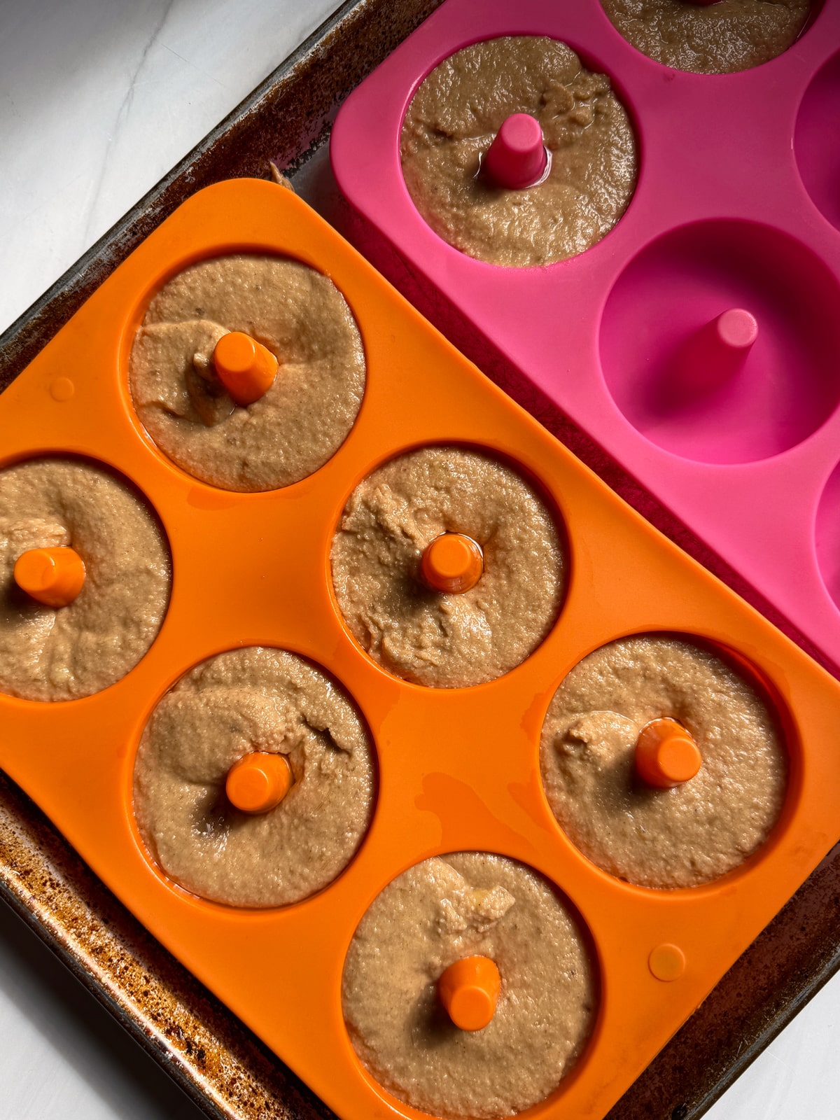 Donut batter in silicone donut molds.