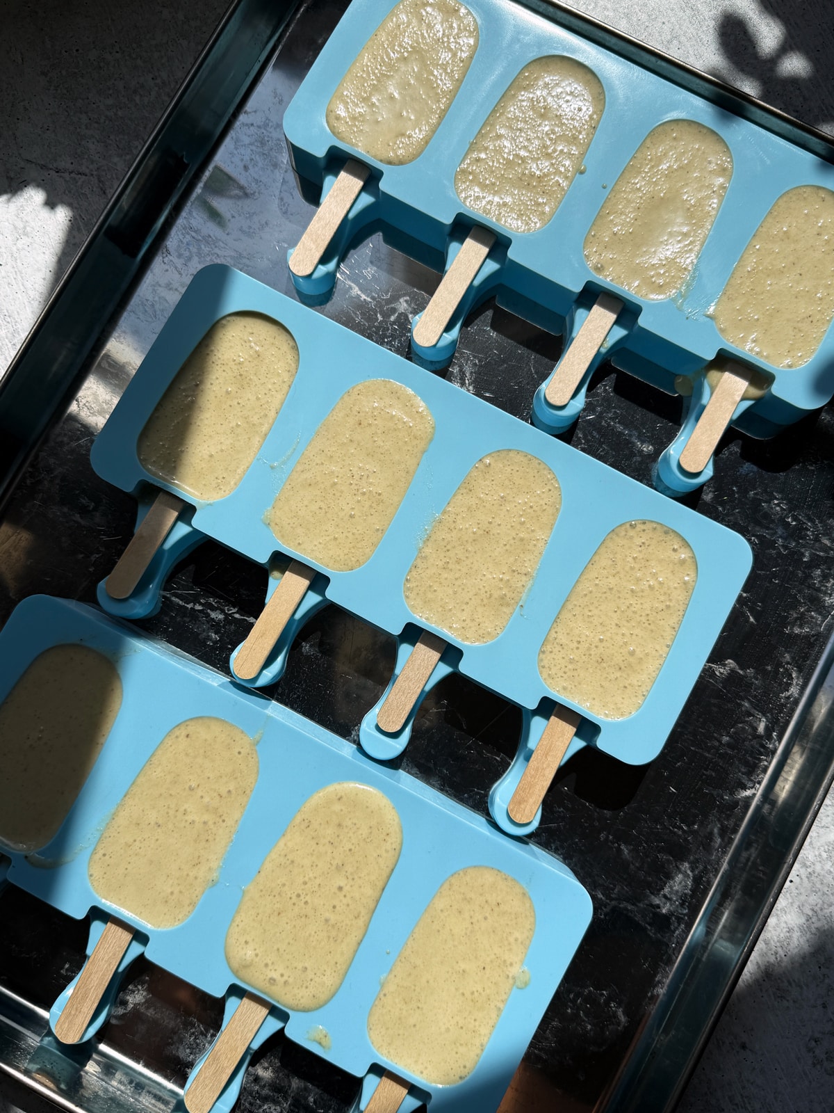 Filling in silicone molds, ready to freeze.