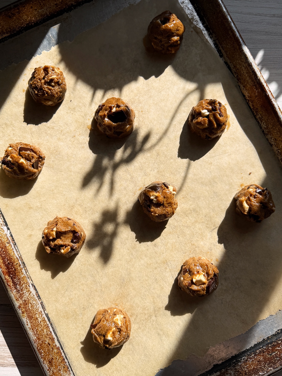 Cookie dough on lined baking sheet.