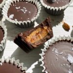 Bite of an almond butter cup to show the inside.