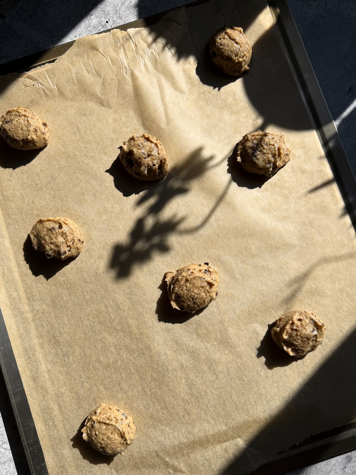 Cookie dough on lined baking sheet.