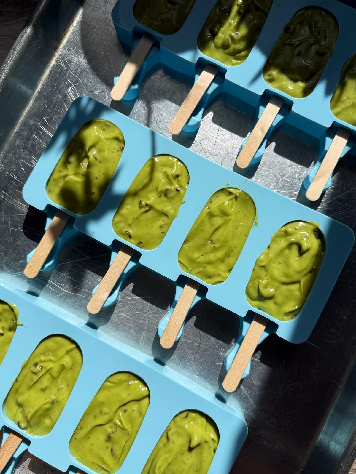 Ice cream filling in popsicle molds.