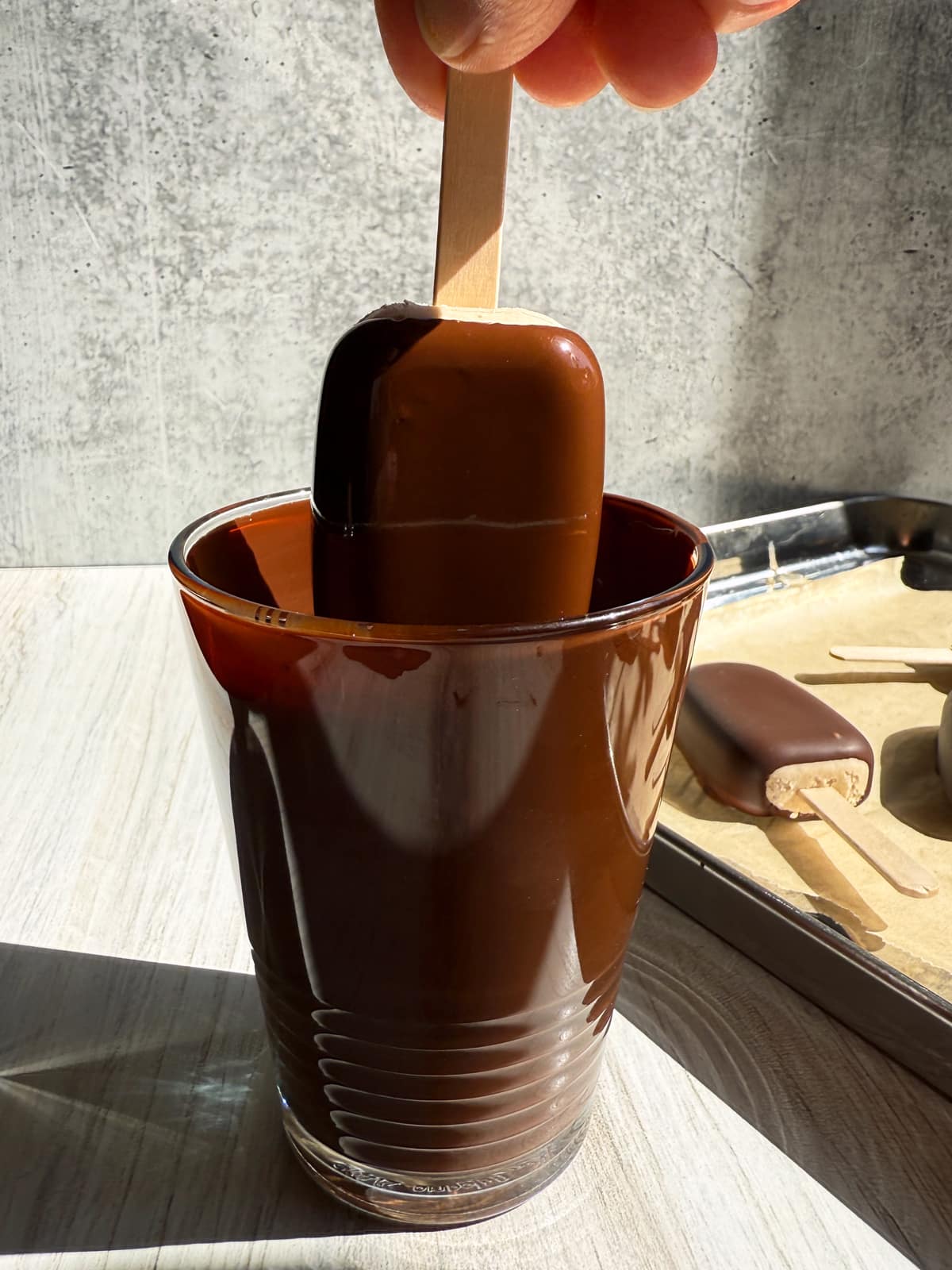 Dipping the ice cream filling into melted chocolate.