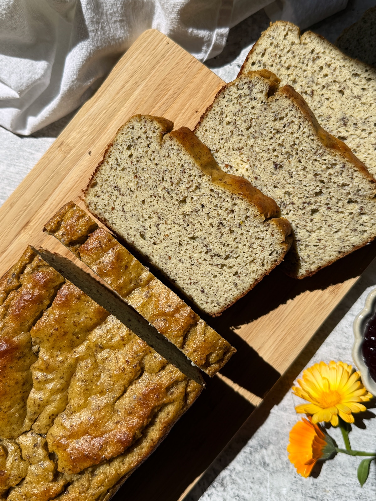 Gluten free pea protein bread on small cutting board.