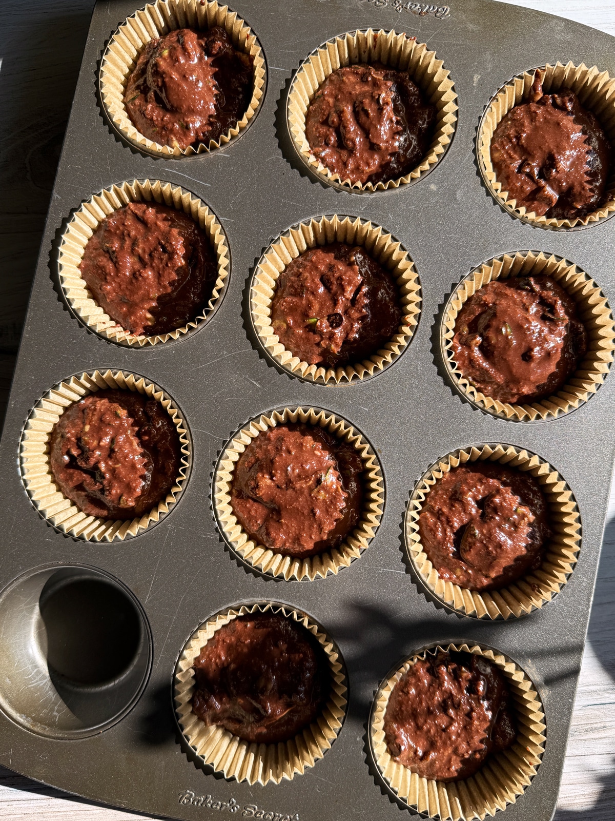 Batter in lined muffin tin.