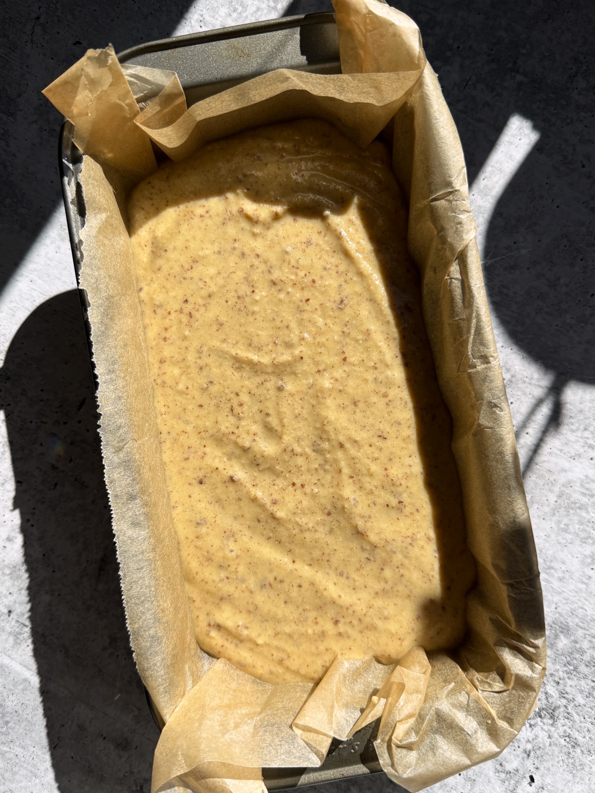 Batter for bread in lined loaf pan.