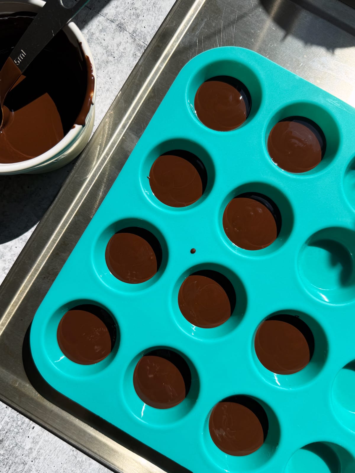 Melted chocolate in mini silicone cupcake mold.
