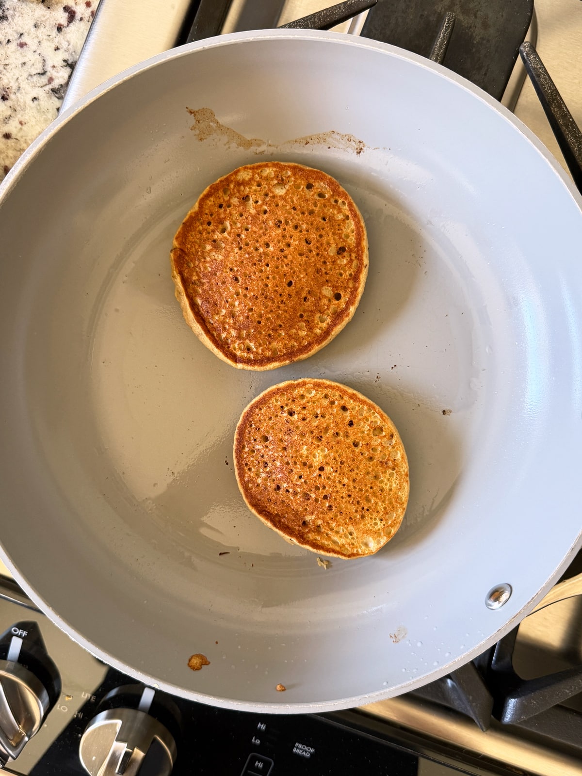 Baking the pancakes on a frying pan.