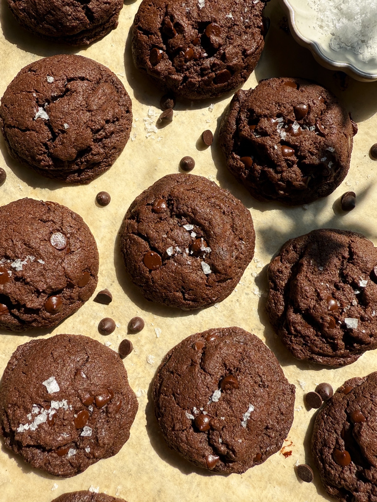 Baked chocolate buckwheat cookie on parchment paper.