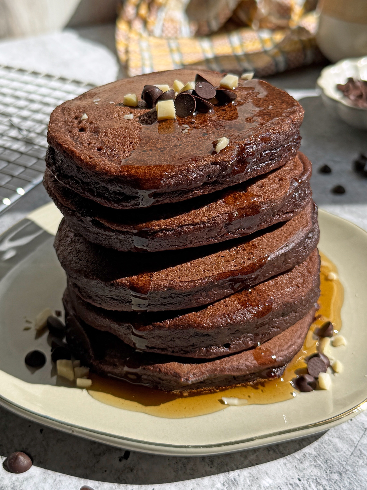 Stack of 5 pancakes drizzle with maple syrup.