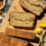 Slices of cinnamon swirl banana bread on cutting board.