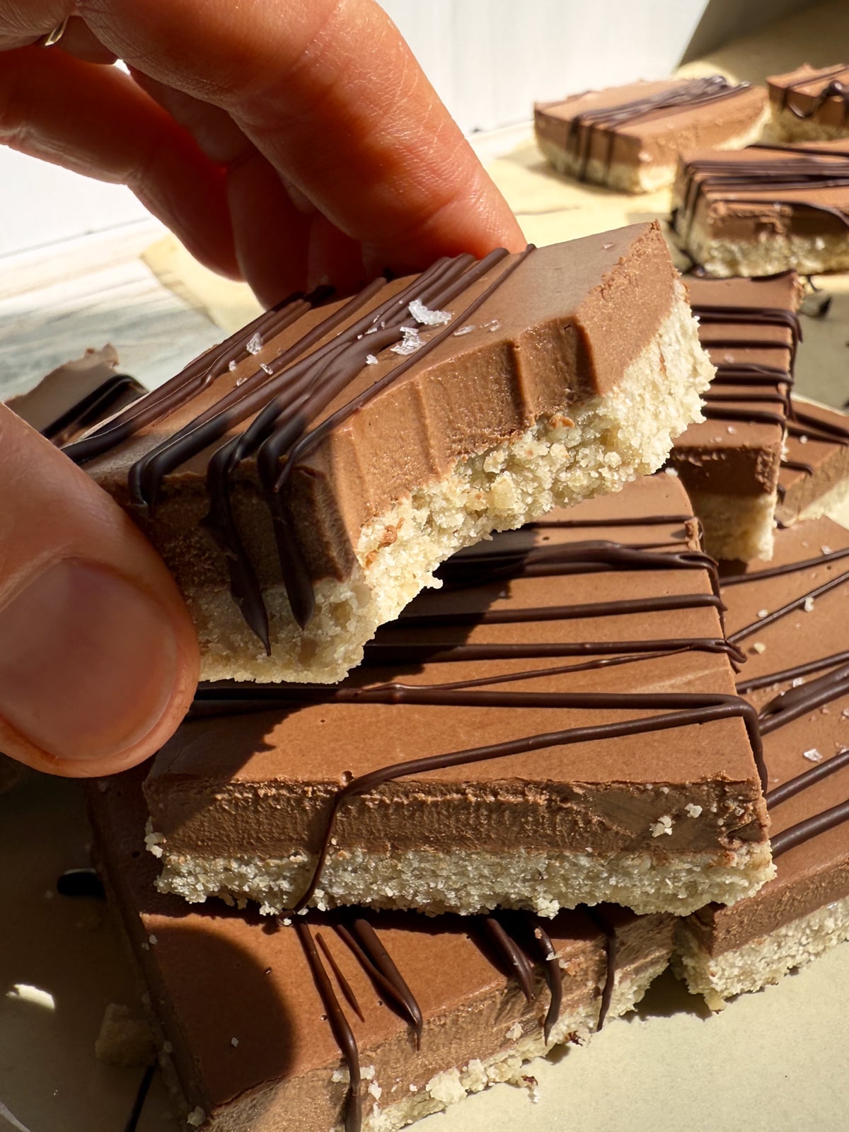 Holding a bar with a bite to show texture.