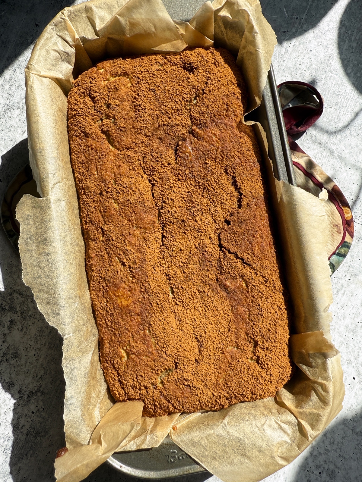Freshly baked loaf in loaf pan.