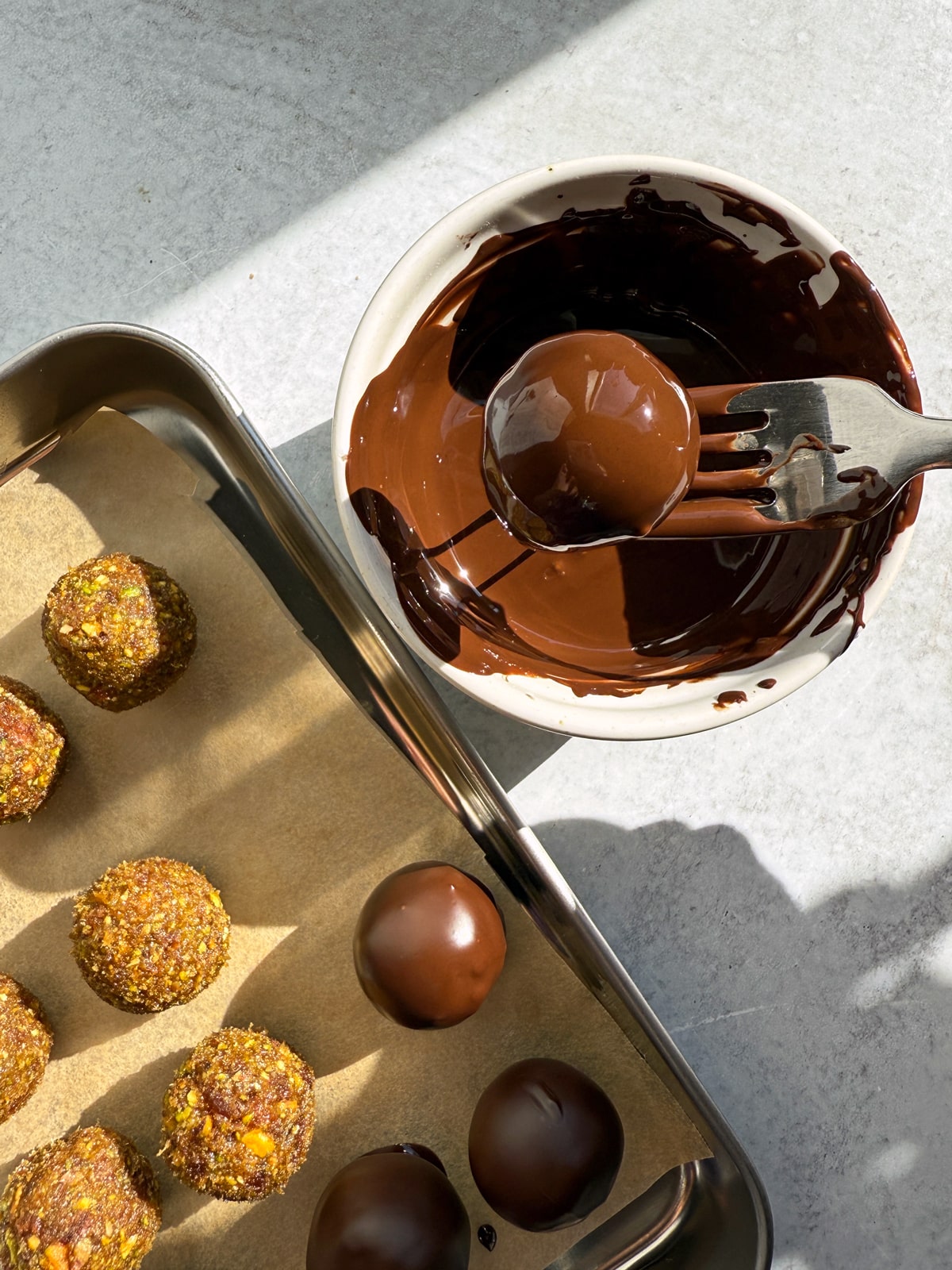 Dipping the filling in dark chocolate.