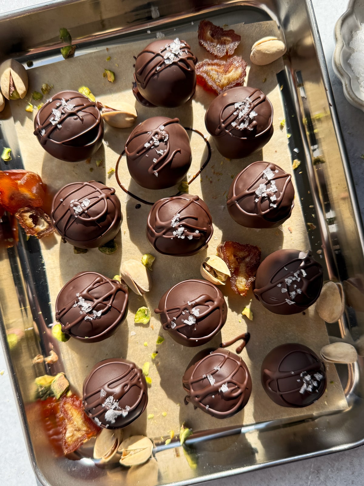 Coated and decorated pistachio date balls.