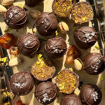 Date and pistachio balls dipped in chocolate.