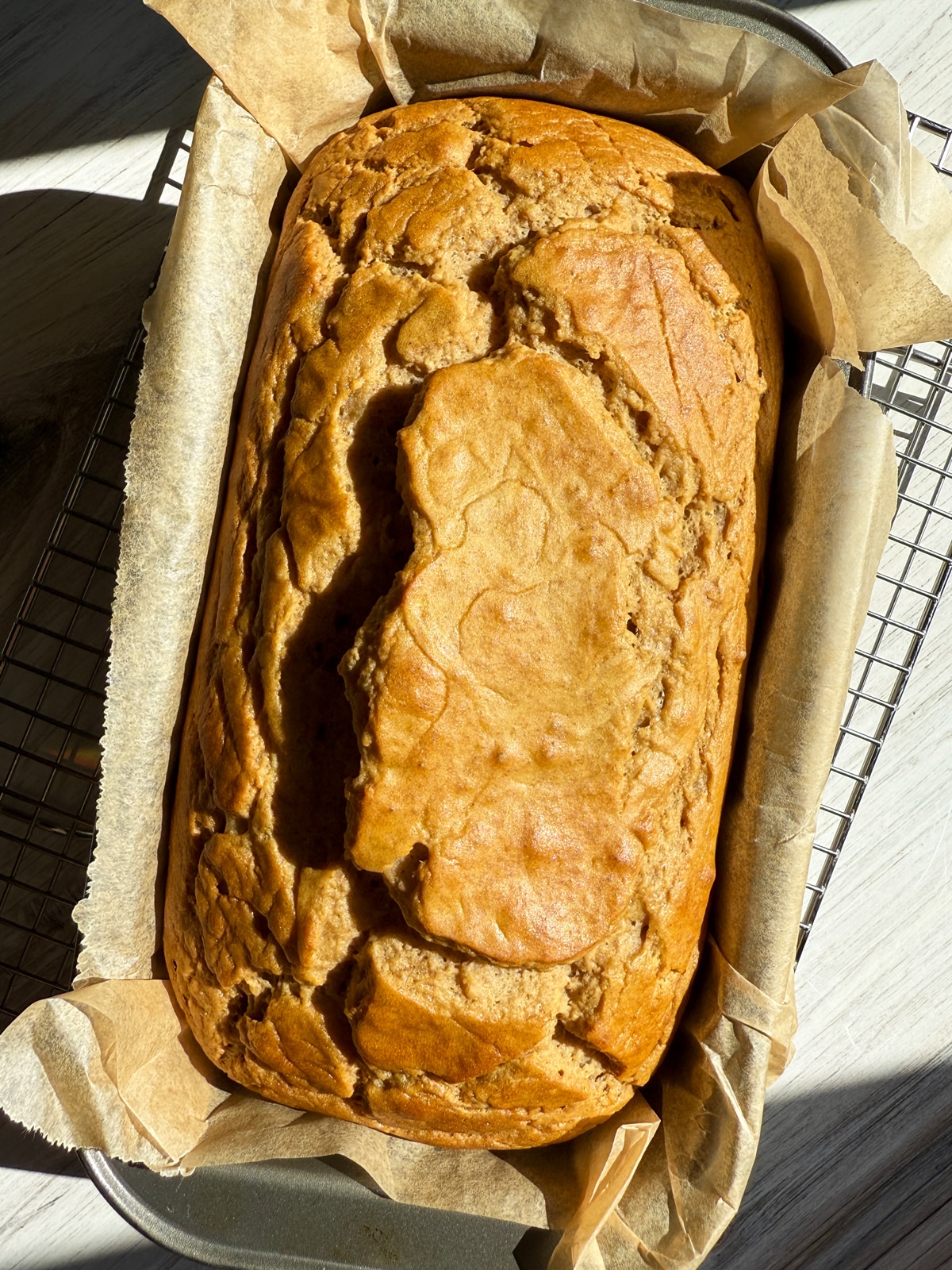 Freshly baked loaf still in the loaf pan.