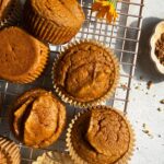 Paleo pumpkin protein muffins on wire rack.