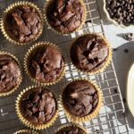 Chocolate pumpkin protein muffins on wire cooling rack.