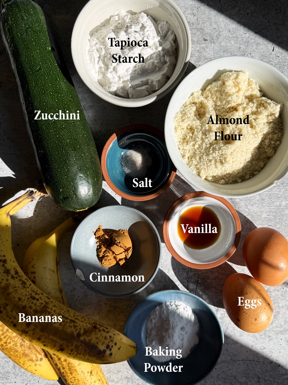 Ingredients needed to make pancakes with ripe bananas and fresh zucchini.
