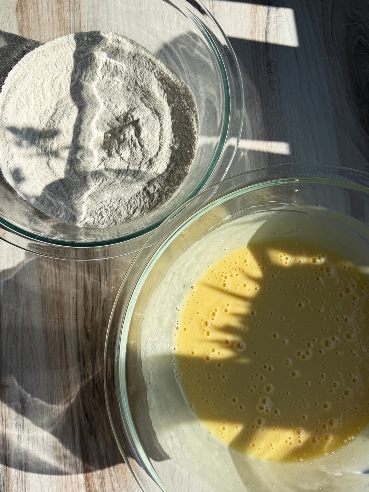 Making the bread by combining the dry ingredients in one bowl and the wet in another.