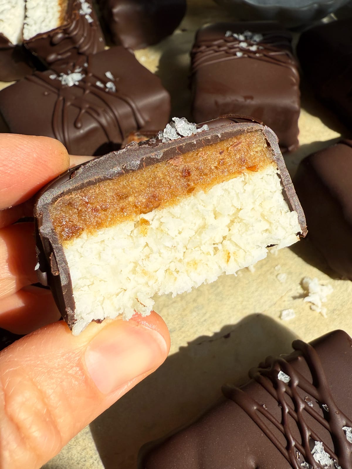 Holding a coconut caramel bar.