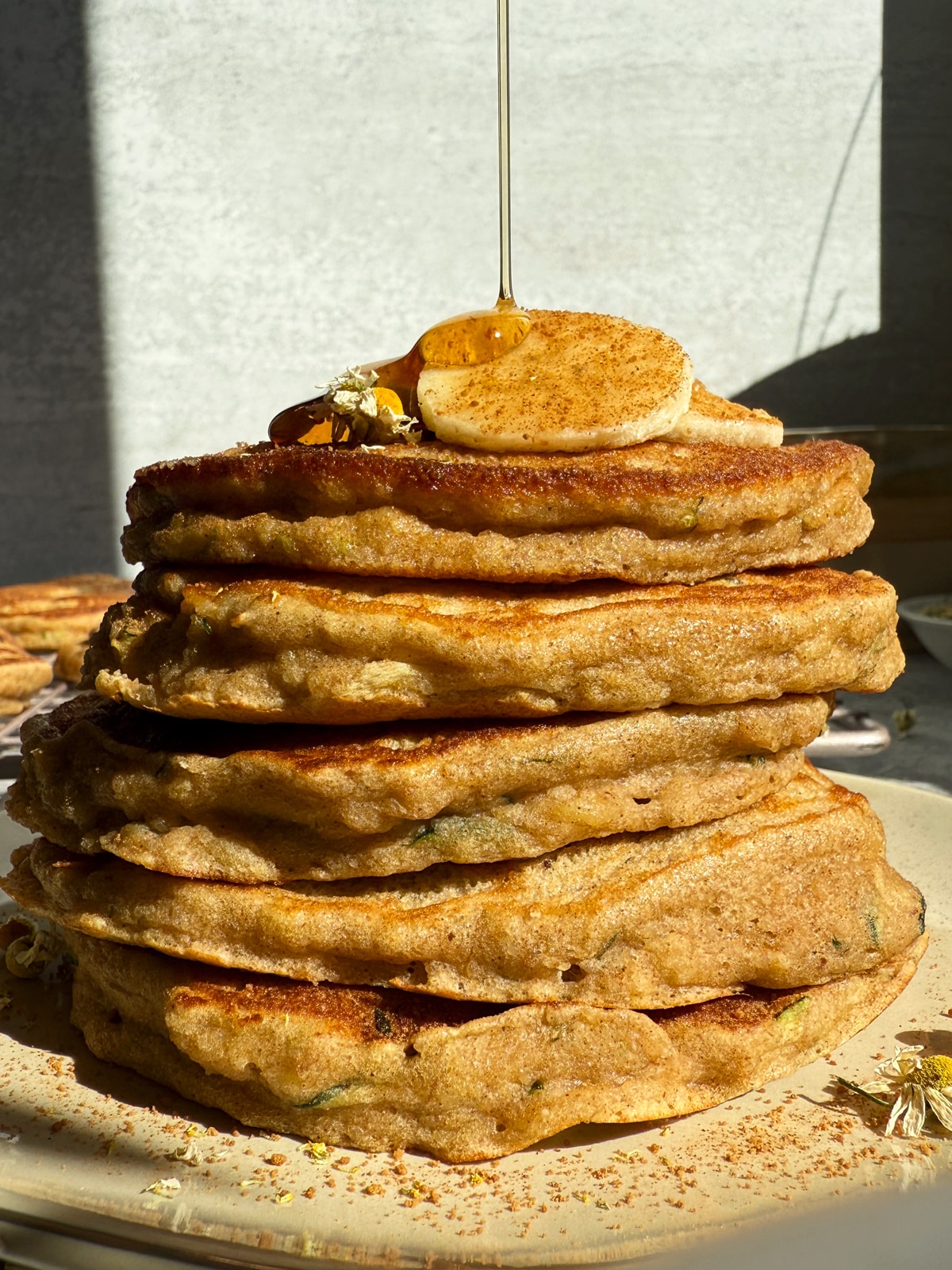Drizzling maple syrup over the zucchini banana pancakes.