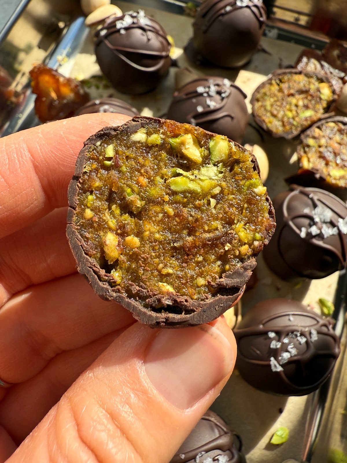 Holding a date ball that's been cut in half.