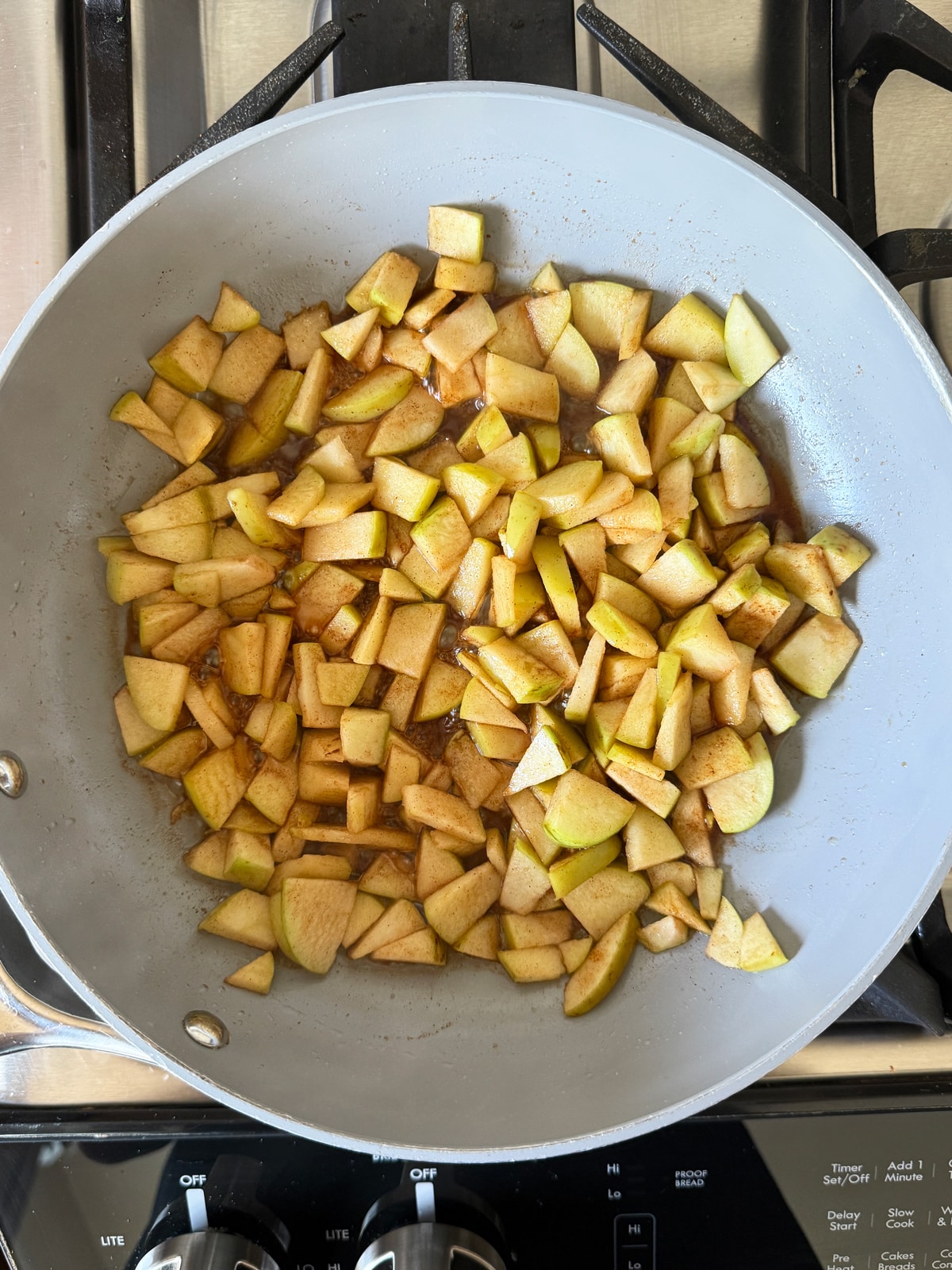 Cooking the apples on a frying pan.