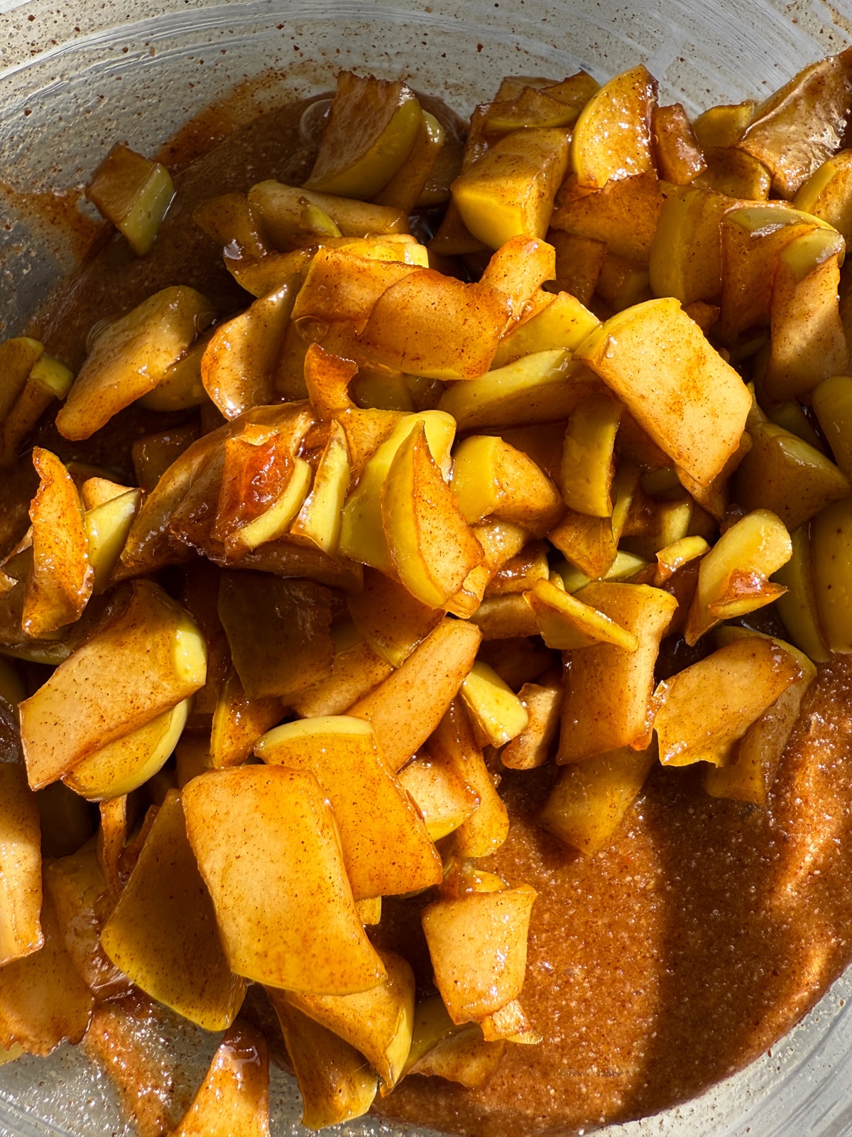 Adding the cooked apples to the batter.