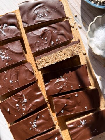 Top view of protein bars on wooden cutting board.