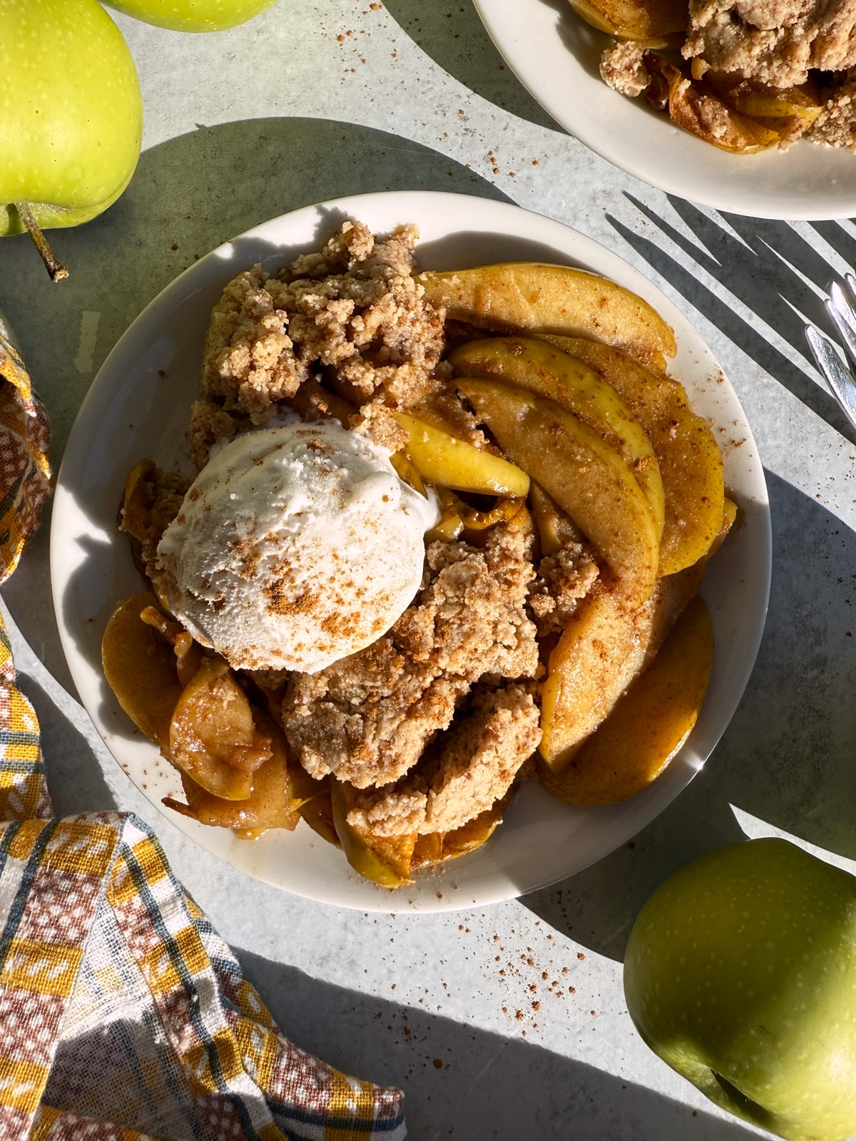 Paleo apple cobbler topped with ice cream.