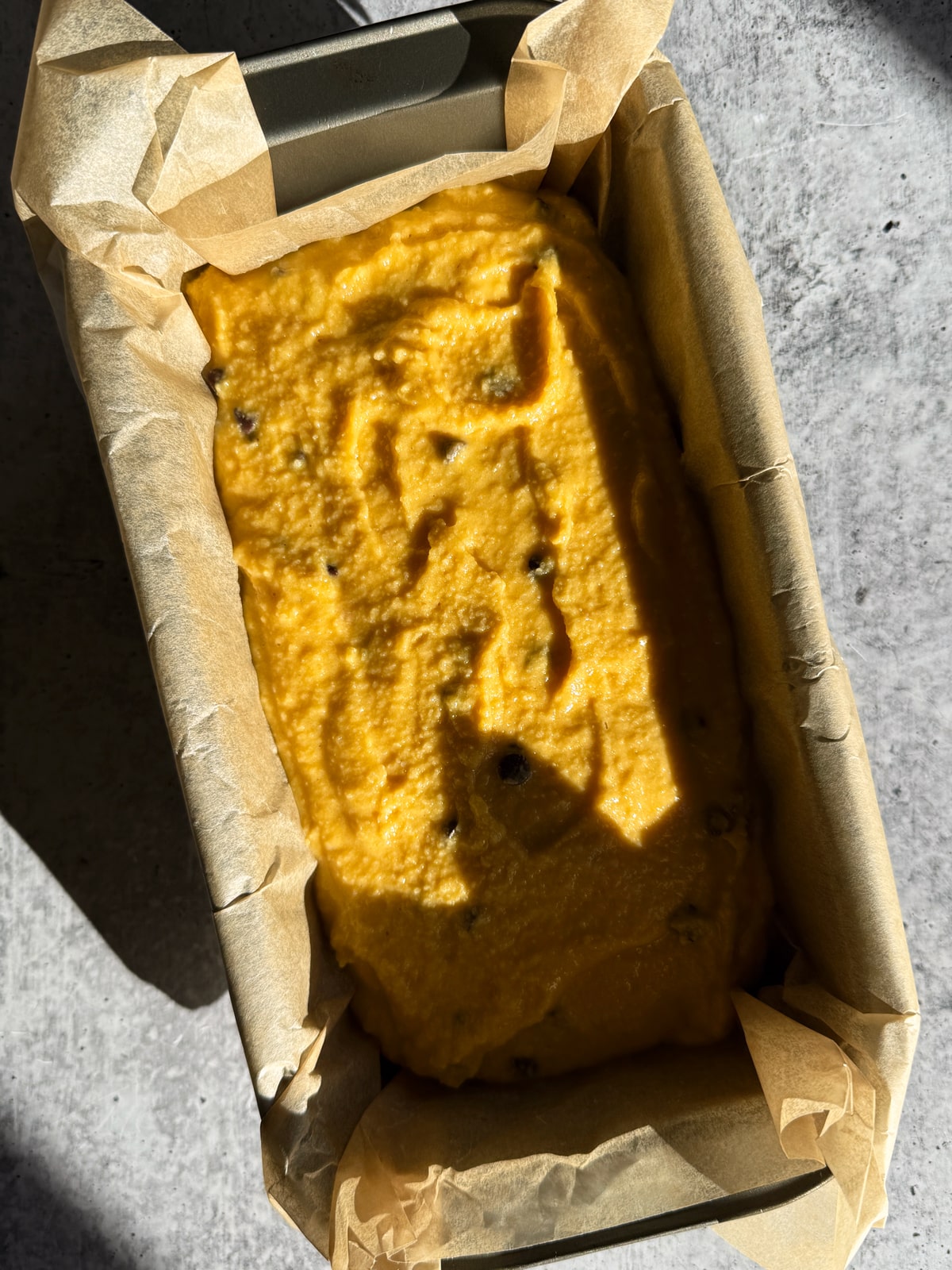 Batter in lined loaf pan, ready to bake.