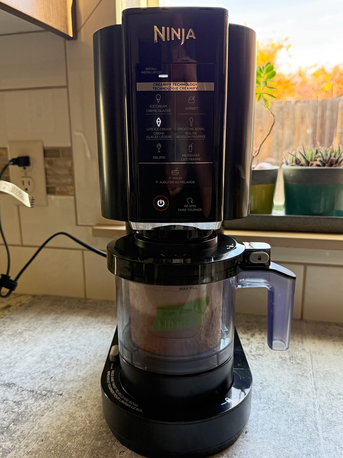 Blending the ice cream in the Ninja Creami machine.
