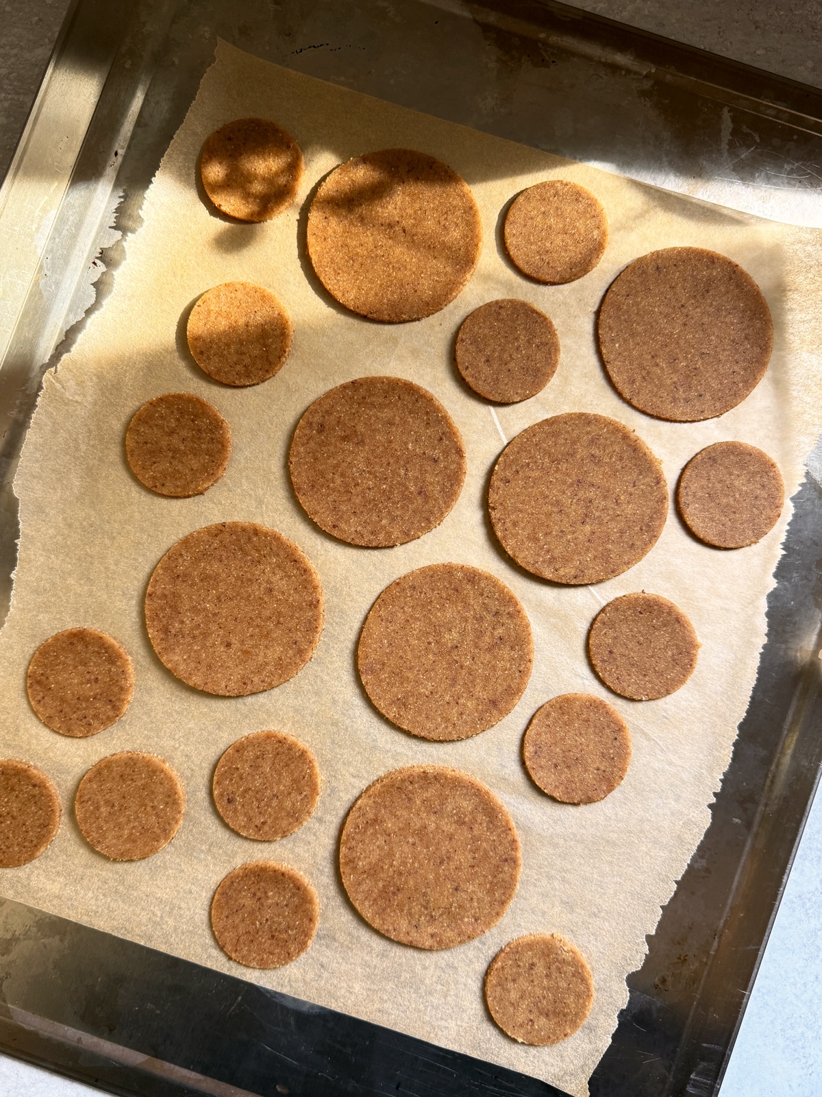 Unbaked cookies on lined baking sheet.