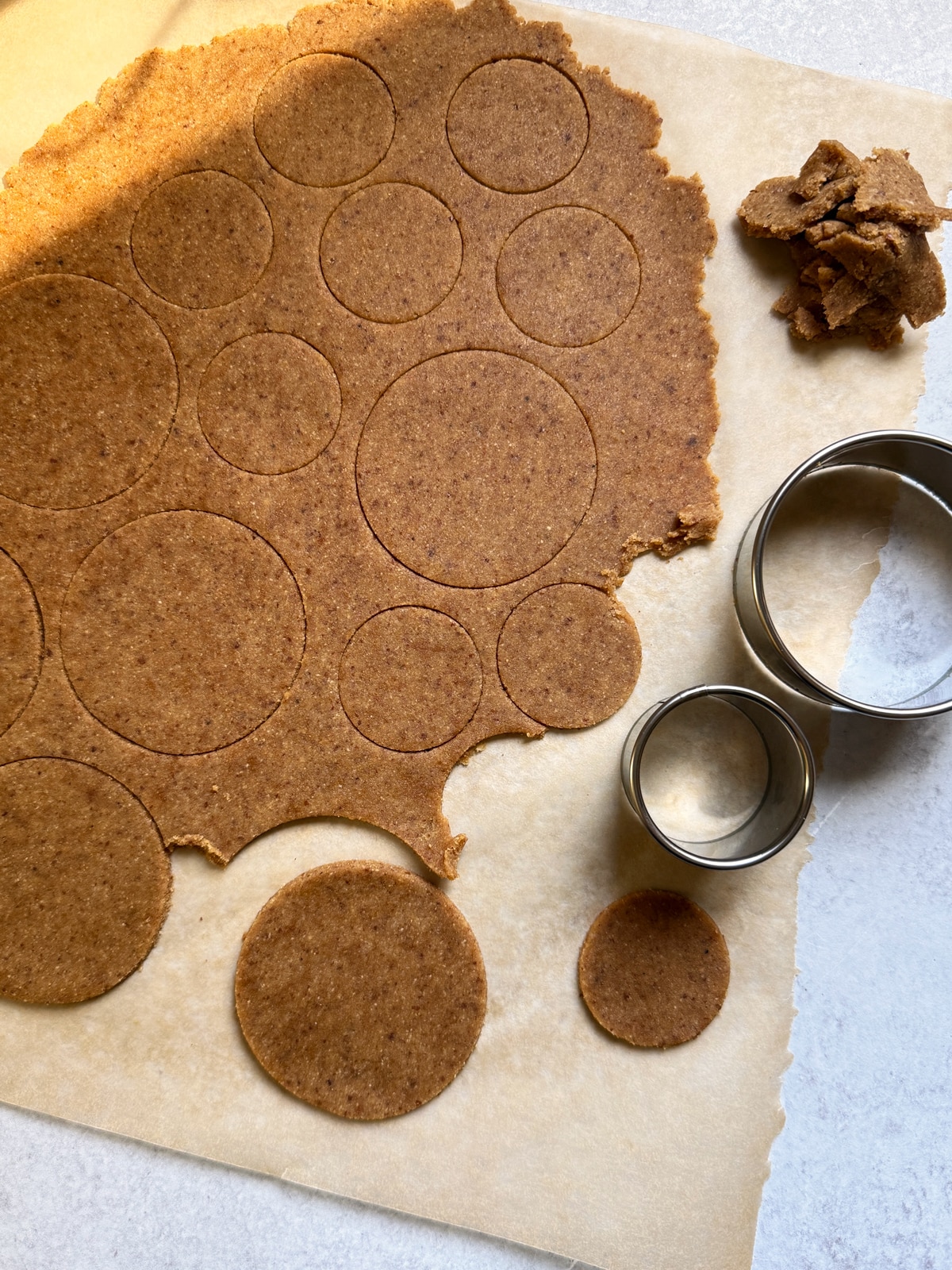 Rolling and cutting the dough into shapes.