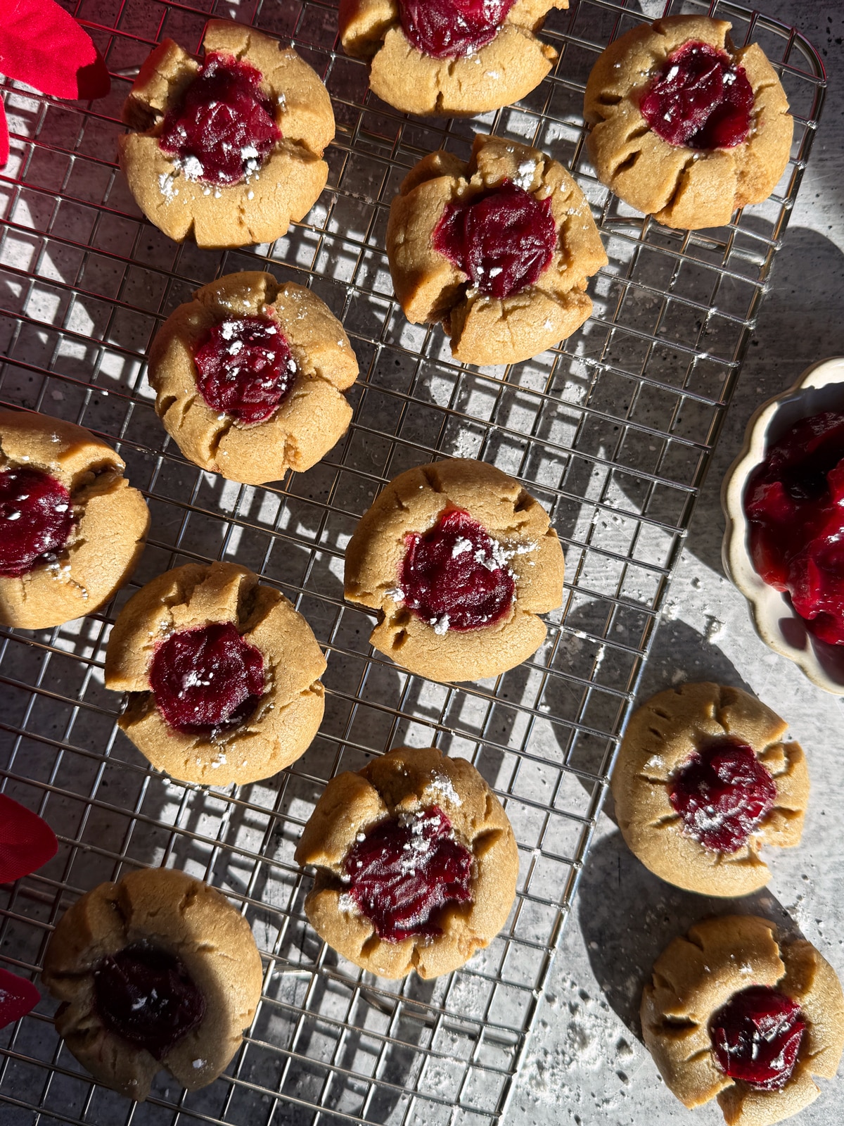 Paleo cranberry thumbprint cookies on wire cooling rack.
