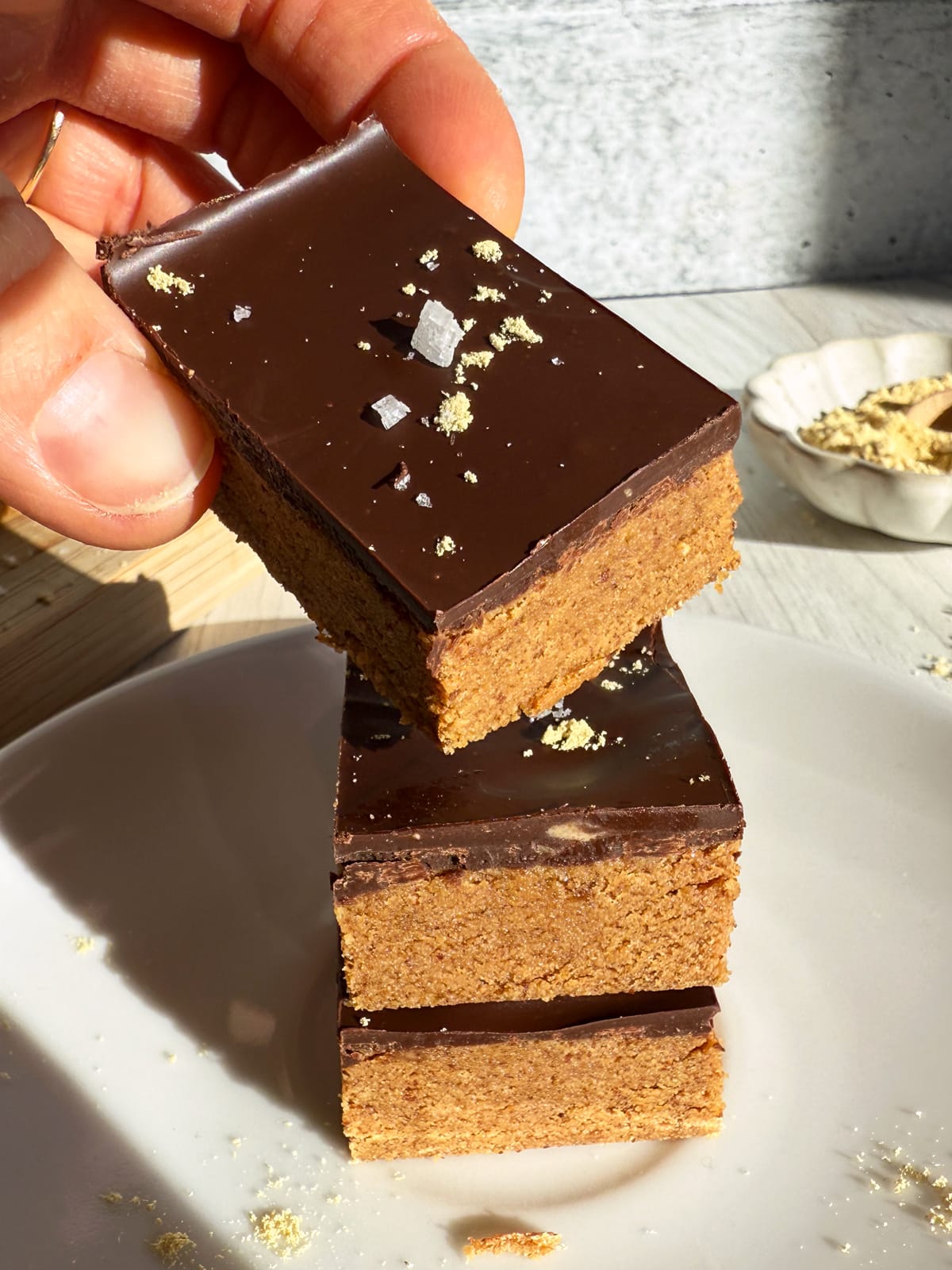 Grabbing a protein bar from a stack of 3.