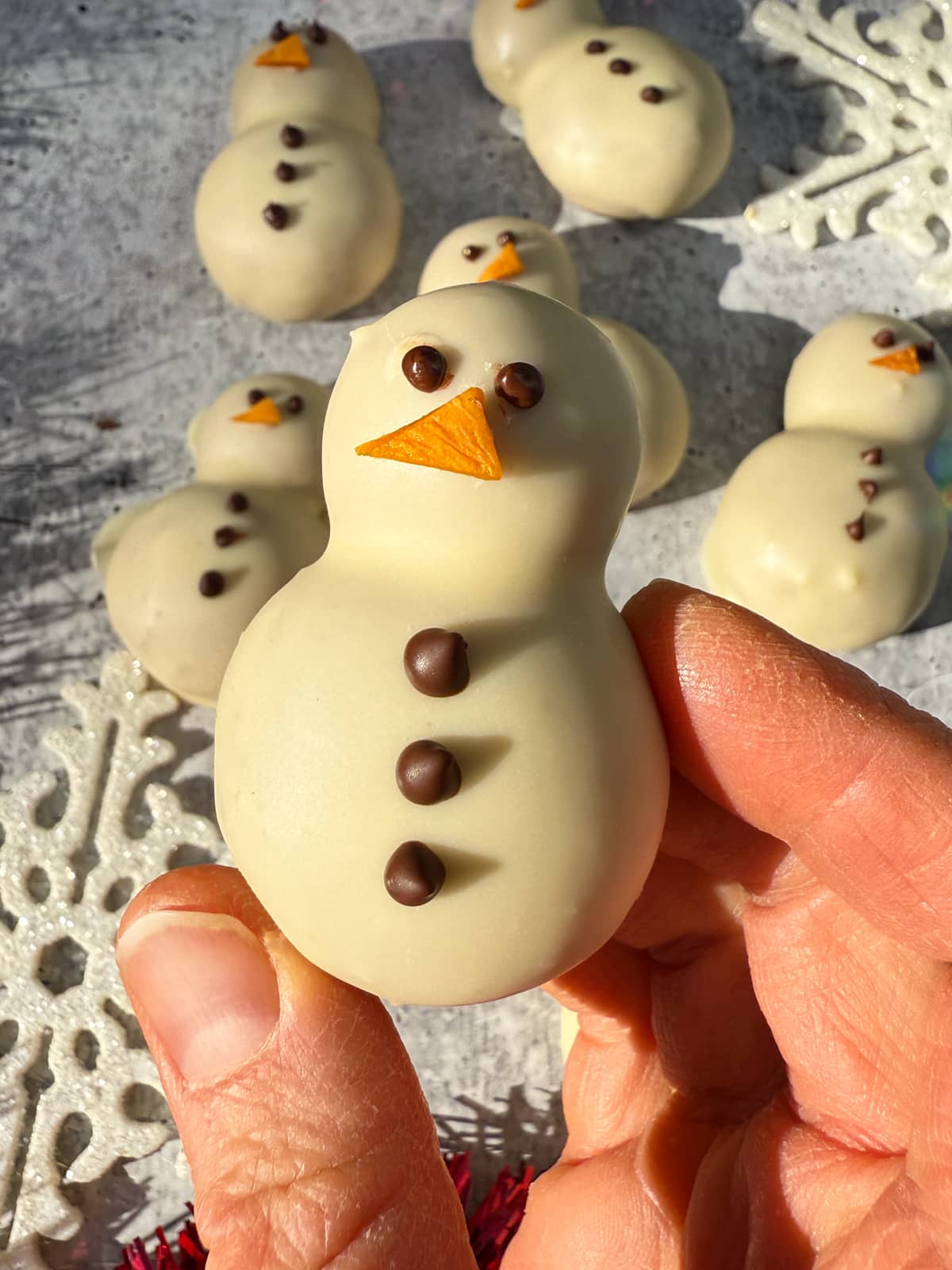Holding a snowman protein ball.
