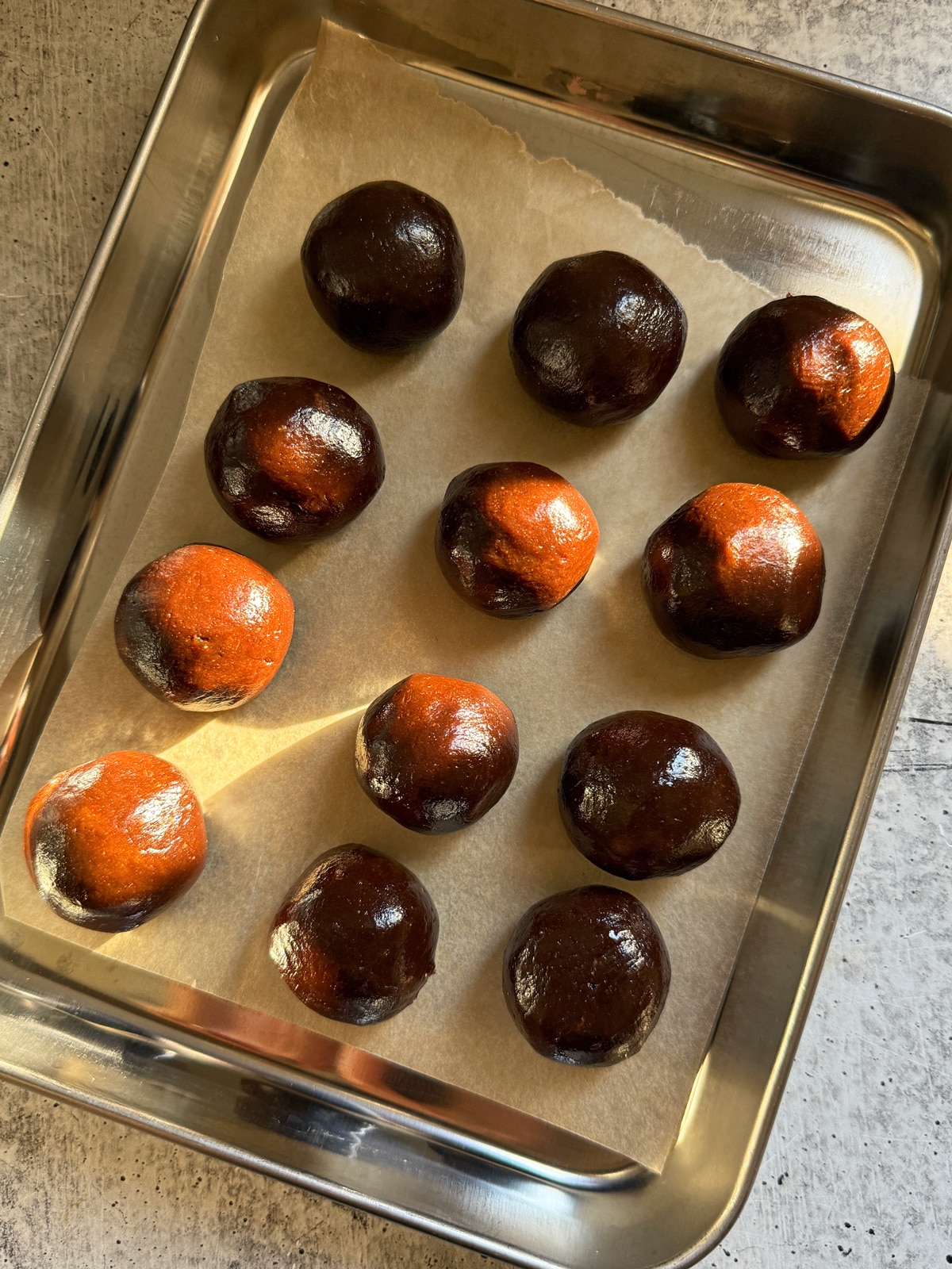 Rolled filling on lined baking sheet.