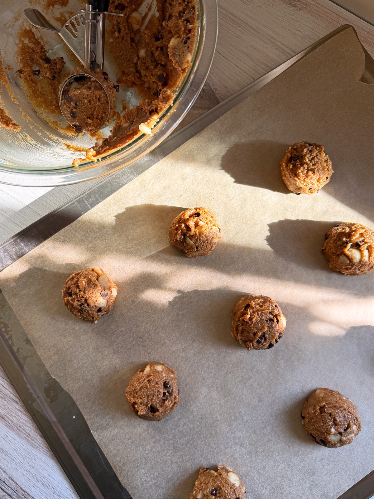 Cookie dough on lined baking sheet.