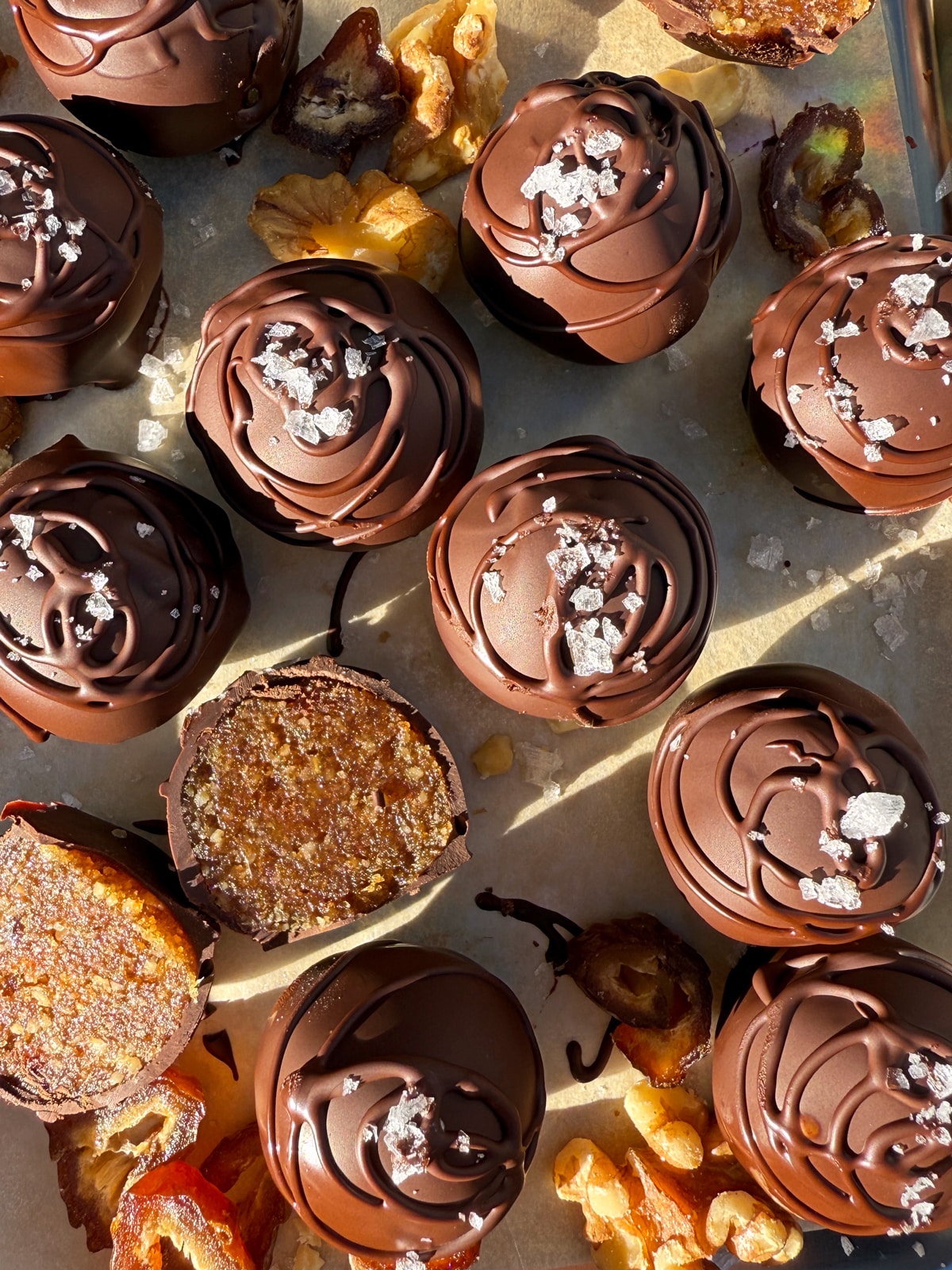 Overhead view of walnut date balls topped with flaked salt.