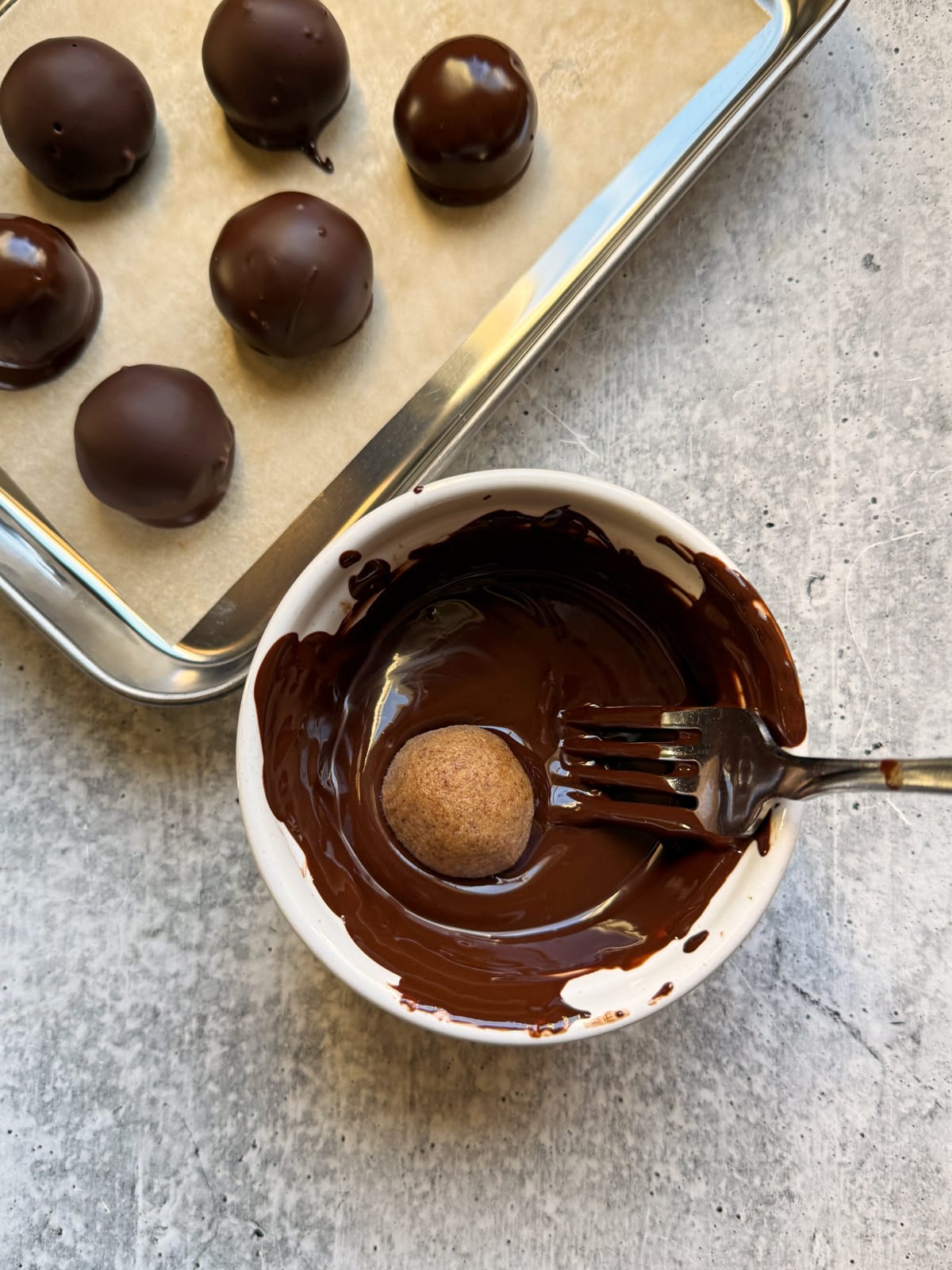 Dipping the fillings into melted chocolate.