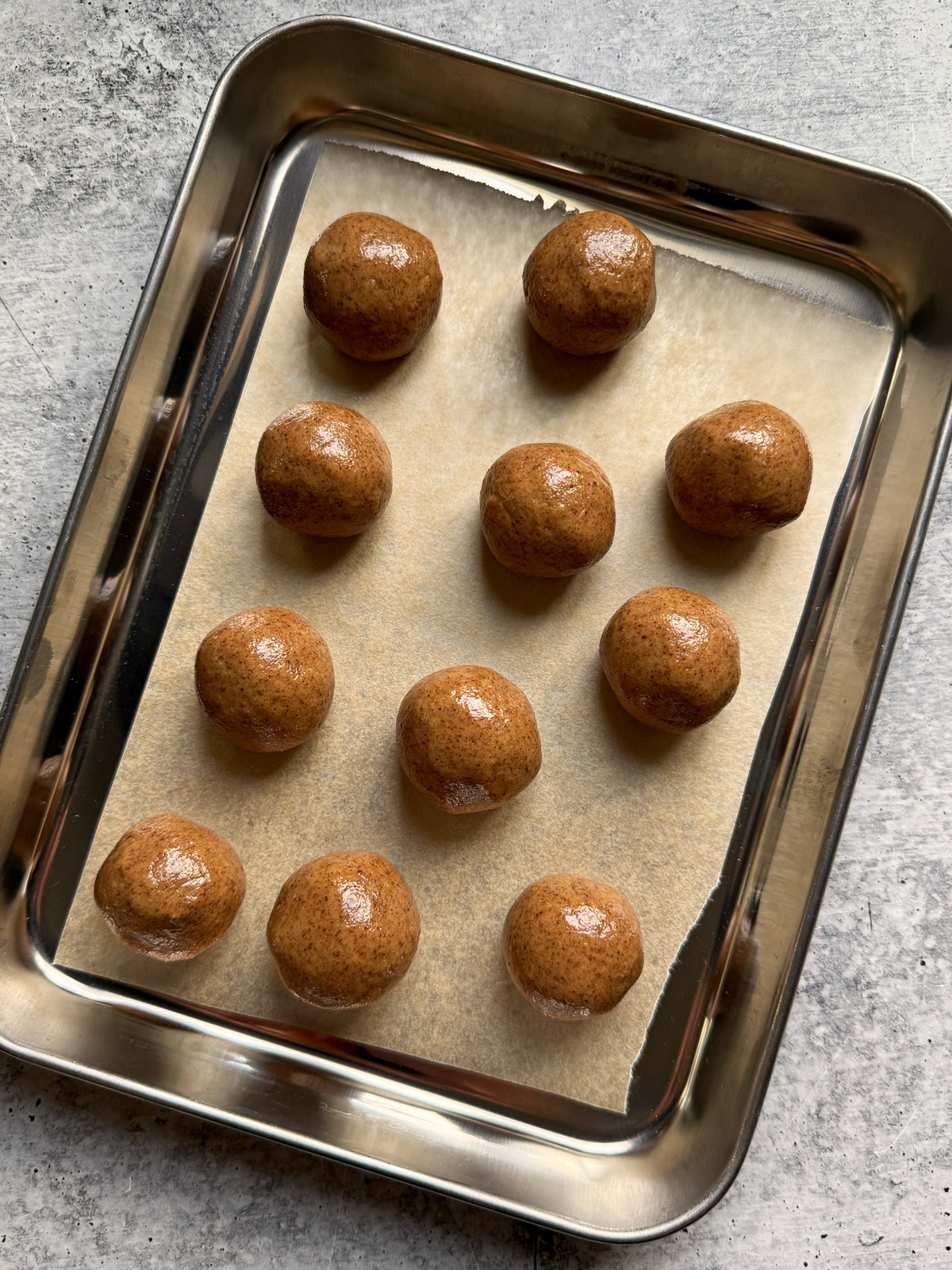 Filling rolled into balls and place on a lined baking sheet.